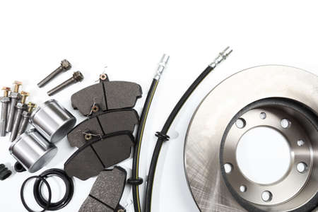 brake parts on white: brake pads, disc, brake hose, guides, cylinders - Image