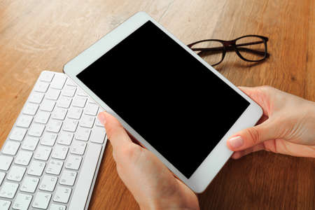 female hands holding smart phone on wooden background  , place for your text  - Imageの写真素材