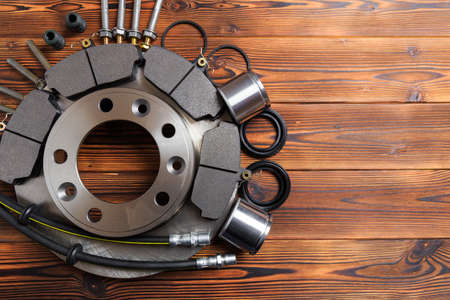 brake parts on wooden background  brake pads, disc, brake hose, guides, cylindersの写真素材
