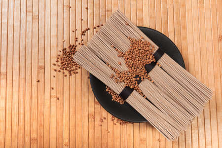 Buckwheat noodles closeup. Raw food ingredient. Dried buckwheat soba noodles. Traditional Japanese foodの写真素材