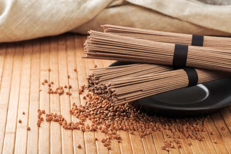 Buckwheat noodles closeup. Raw food ingredient. Dried buckwheat soba noodles. Traditional Japanese foodの写真素材