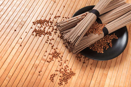 Buckwheat noodles closeup. Raw food ingredient. Dried buckwheat soba noodles. Traditional Japanese foodの写真素材