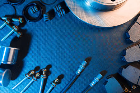 brake parts on dark background  brake pads, disc, brake hose, guides, cylinders