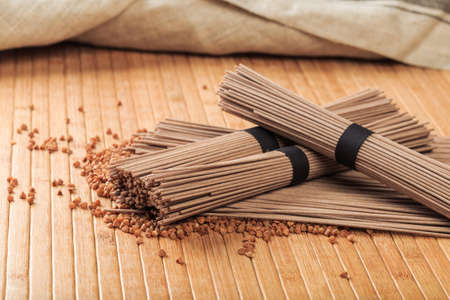 Buckwheat noodles closeup. Raw food ingredient. Dried buckwheat soba noodles. Traditional Japanese foodの写真素材
