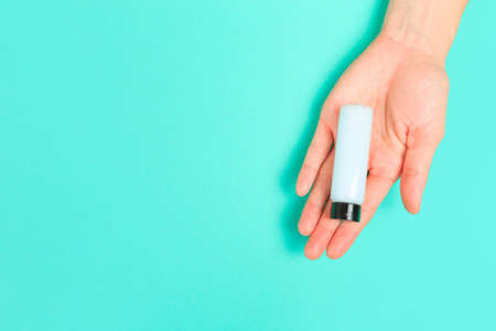 female  manicure. Beautiful young woman's hands with bottles of cosmetics  on pastel background - Imageの写真素材
