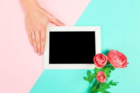 Beautiful young woman's hands holding frame for your text place  on pastel  background - Image