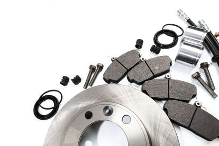 brake parts on white: brake pads, disc, brake hose, guides, cylinders - Image