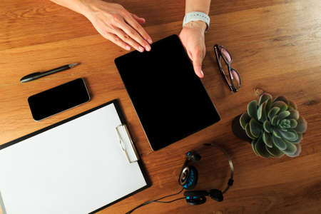 Female hands working on wooden work place with modern gadgets  top view - Image