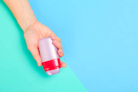 female  manicure. Beautiful young woman's hands with bottles of cosmetics  on pastel background - Imageの写真素材
