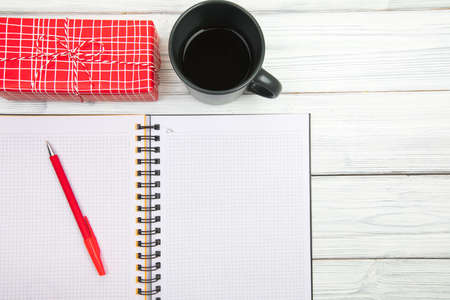 Blank open notepad, pine branches and Christmas decorations on a white wooden table. Space for text....