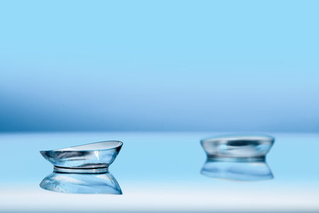 contact lenses on blue background close up viewの写真素材
