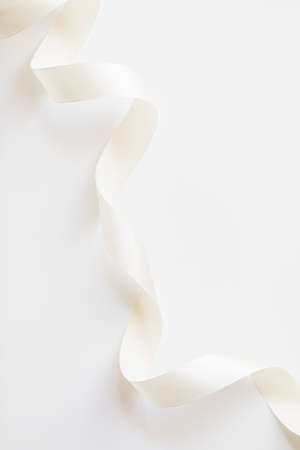 loops of white ribbon on gray text place - Image