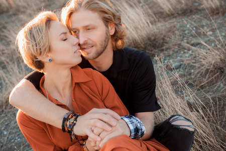 happy and loving couple in the setting sunの写真素材