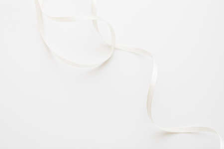 loops of white ribbon on gray text place - Image