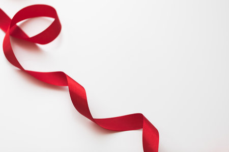 loops of red ribbon on gray text place - Imageの写真素材