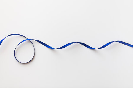 loops of blue ribbon on gray text place - Imageの写真素材