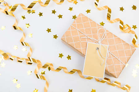 gifts or boxes golden confetti on white table top view. Flat lay composition for birthday, christmas...