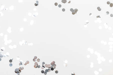 round silver confetti on white background flat lay text place - Image