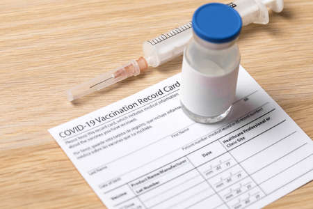 Syringe and vaccine vial for corona virus are on medical form required for travel and tourism.の写真素材