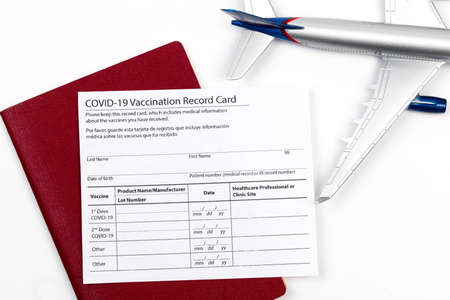COVID-19 vaccination record card and tourist passport of traveler for worldwide travel during...