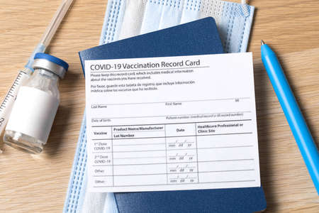 COVID-19 vaccination record card and tourist passport for worldwide travel during coronavirus pandemic.の写真素材