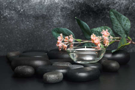 Spa stones  and candle on black background - Imageの写真素材