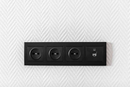 Electrical household switches and sockets close up. Minimalist interior design. Stylish bedroom and living roomの写真素材