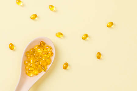 Close up of  oil filled capsules on spoon suitable for: fish oil, omega 3, omega 6, omega 9,  vitamin A, vitamin D, vitamin D3, vitamin Eのeditorial素材