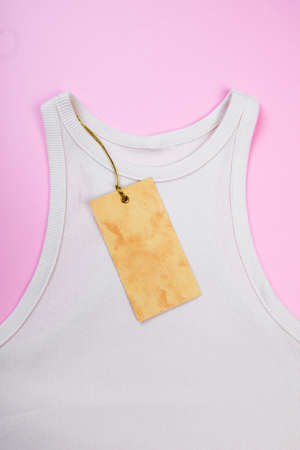price tag hang over white  t-shirt on  pink backgroundの写真素材