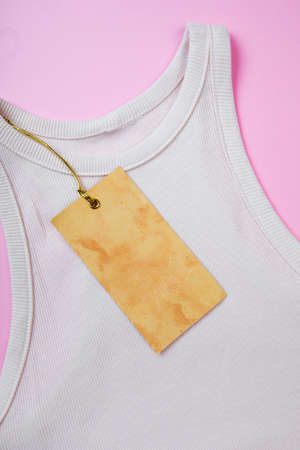 price tag hang over white  t-shirt on  pink background