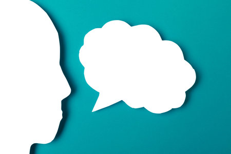 paper face and speech bubble on colorbackground copy space for text, communication, symbolicの写真素材