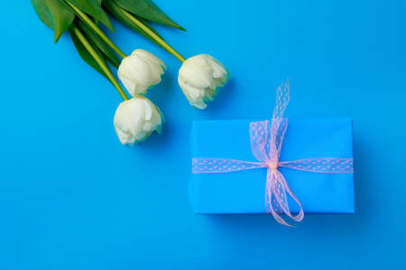 Gift box and Spring flowers on color background. Happy women's day. Happy Mothers day.Hello Springの写真素材