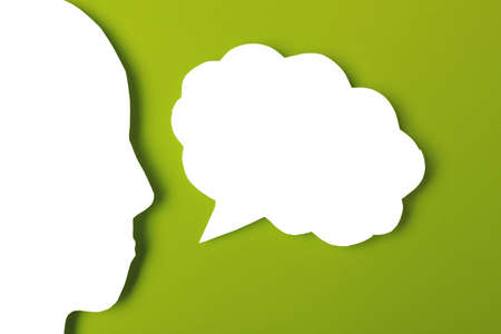 paper face and speech bubble on colorbackground copy space for text, communication, symbolicの写真素材