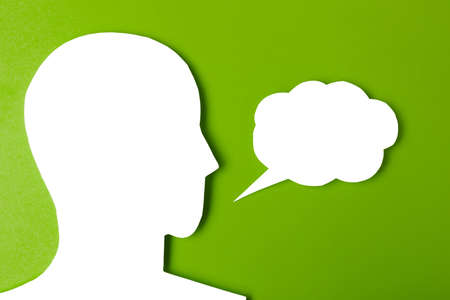 paper face and speech bubble on colorbackground copy space for text, communication, symbolicの写真素材