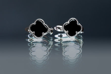 earrings with black enamel on black backgroundの写真素材