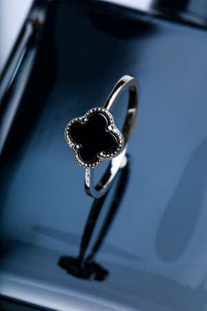 ring with black enamel on black backgroundの写真素材