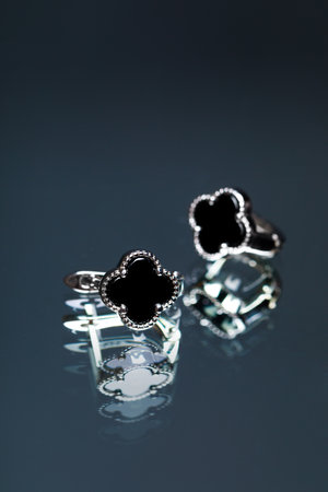 earrings with black enamel on black background