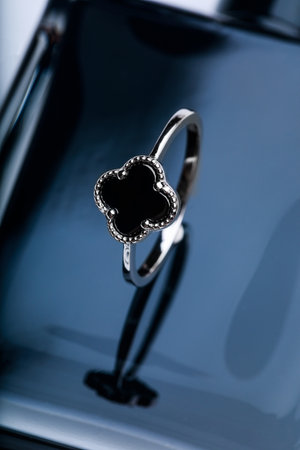 ring with black enamel on black background