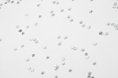 sparkles silver stars on white background with text placeの写真素材