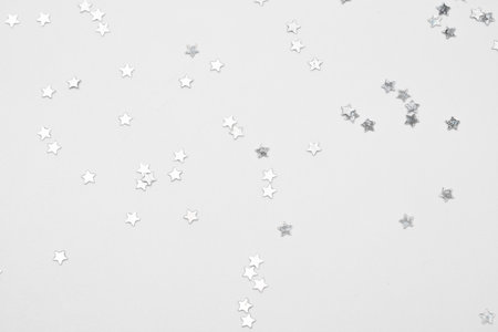 sparkles silver stars on white background with text placeの写真素材