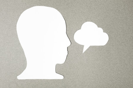 paper face and speech bubble on colorbackground copy space for text, communication, symbolicの写真素材