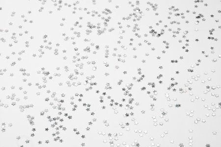 sparkles silver stars on white background with text place