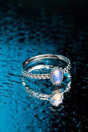 ring with Moonstone   on black background  with water dropsの写真素材