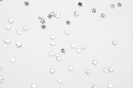 sparkles silver stars on white background with text place