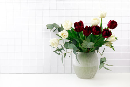 Spring flowers in vase on white backroundの写真素材