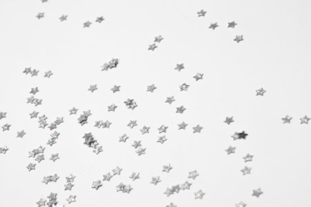 sparkles silver stars on white background with text placeの写真素材