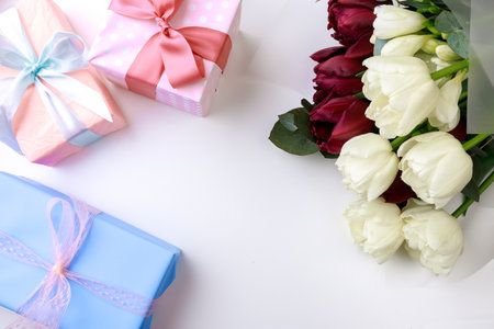 tulips and gift box on white background. Stylish soft image of spring flowers. Happy womens day. Happy Mothers dayの写真素材