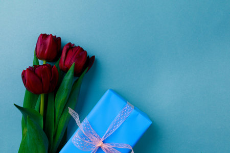 Gift box and spring flowers on color background. Stylish soft image of spring flowers. Happy womens day. Happy Mothers day.Hello Springの写真素材