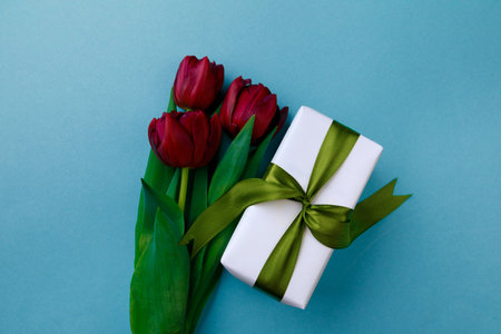 Gift box and spring flowers on color background. Stylish soft image of spring flowers. Happy womens day. Happy Mothers day.Hello Springの写真素材
