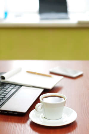 Close-up of coffee cup standing on office table